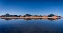 Mountain reflections on the water covering the Bonneville Salt Flats.